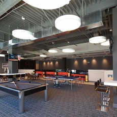 Recreation area with pool table and white hanging lighting fixtures