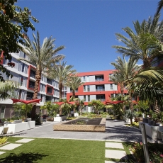 Courtyard of apartment building with palm trees and fountain