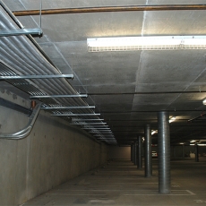 Interior of parking garage with ceiling lights
