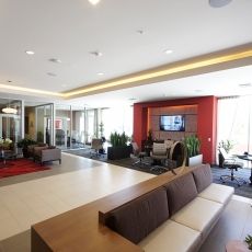 Interior of apartment building with accent lighting on the ceiling and a media center with accent lighting surrounding it