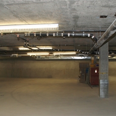 Interior of parking garage with ceiling lights