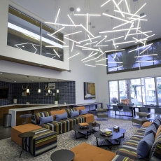 Interior of building with white walls and suspended lighting fixtures