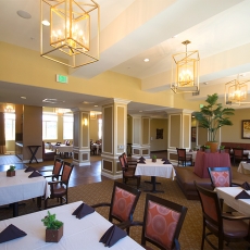Restaurant dining area with gold lighting fixtures hanging from the ceiling