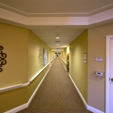 Hallway with ceiling lights and a door on the right labeled "Electric Room"